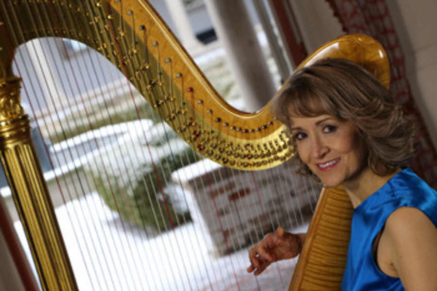 Ann in blue dress-2 Ann Lobotzke sits at her harp in a blue dress.