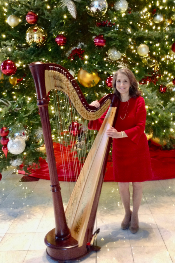 Ann with Christmas tree Ann Lobotzke stands in front of a Christmas tree
